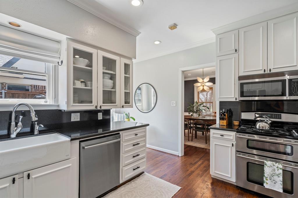 5822 Monticello Avenue Dallas, TX 75206 - Photo 13 of 24 a kitchen with granite countertop a stove a sink and a microwave