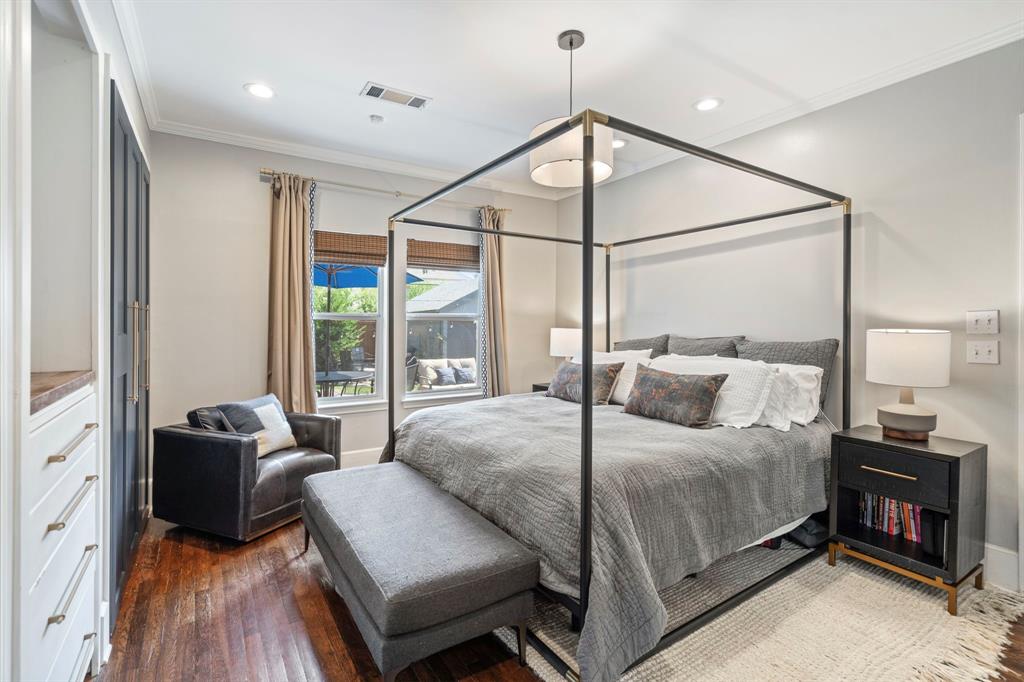 5822 Monticello Avenue Dallas, TX 75206 - Photo 14 of 24 a bedroom with a bed and a chandelier