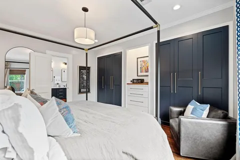 a bedroom with a bed and a chandelier