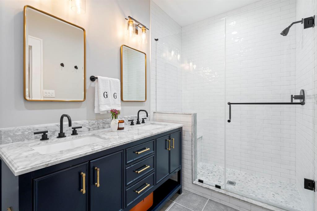 5822 Monticello Avenue Dallas, TX 75206 - Photo 17 of 24 a bathroom with a granite countertop sink and a mirror