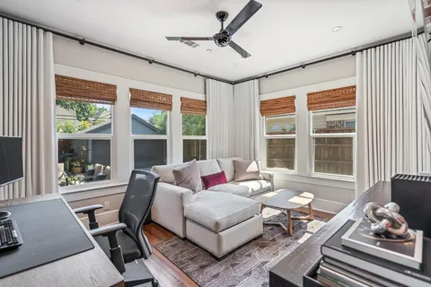 a living room with furniture and floor to ceiling windows