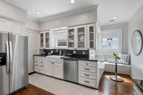 a kitchen with stainless steel appliances a stove a sink and a refrigerator