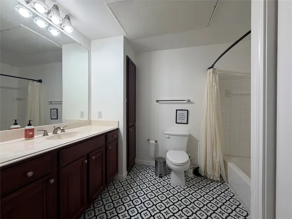 a bathroom with a double vanity sink mirror and toilet