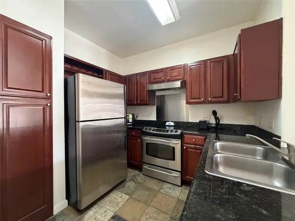a kitchen with a refrigerator sink and stove