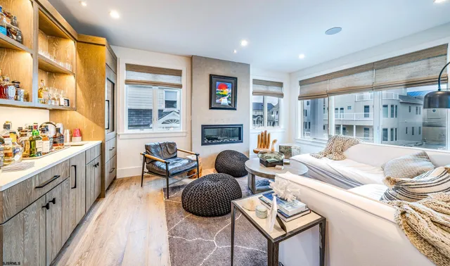 a living room with furniture fireplace and a large window
