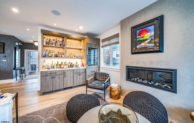 a living room with furniture a rug a fireplace and a flat screen tv
