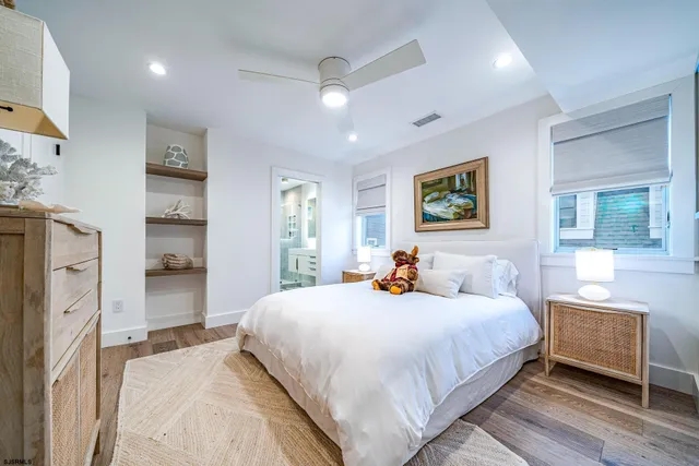 a bedroom with a bed and a refrigerator