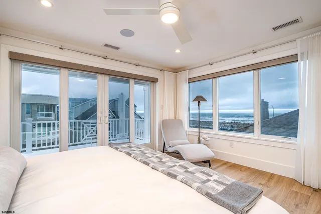 a bedroom with a large bed and a large window