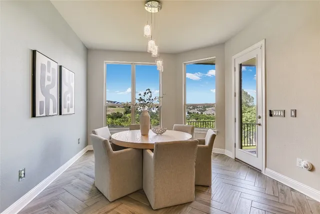 a dining room with furniture potted plants and wooden floor