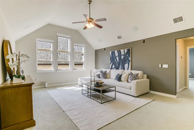 a living room with furniture a flat screen tv and a window