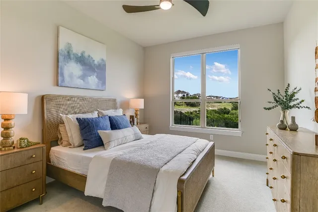 a bedroom with a large bed and a window