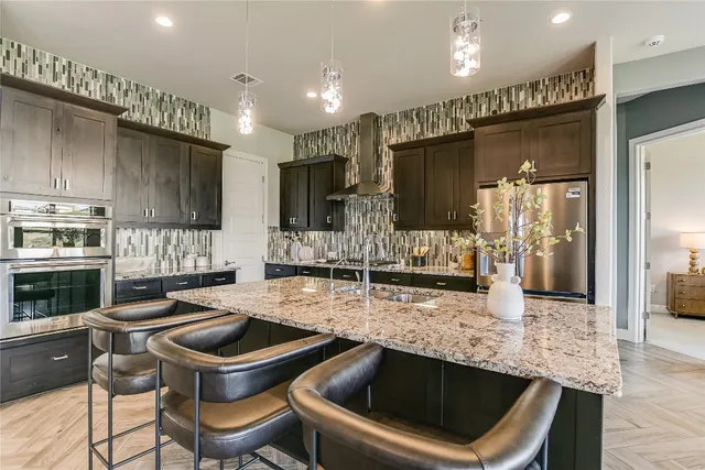 a kitchen with a stove a sink and a refrigerator