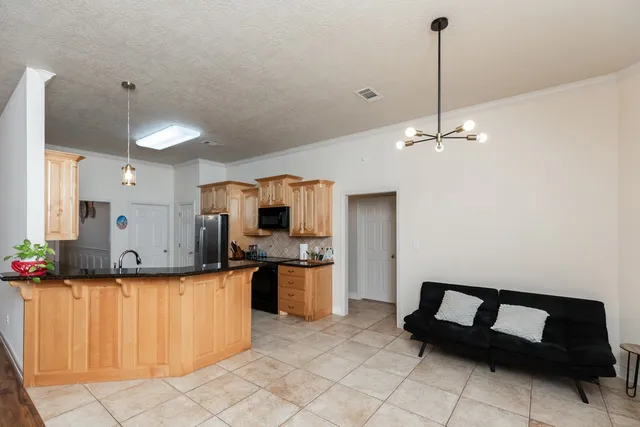 a kitchen with stainless steel appliances kitchen island granite countertop a sink counter space and cabinets