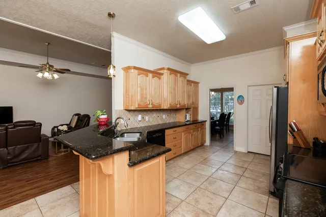 a kitchen with a refrigerator and a stove top oven