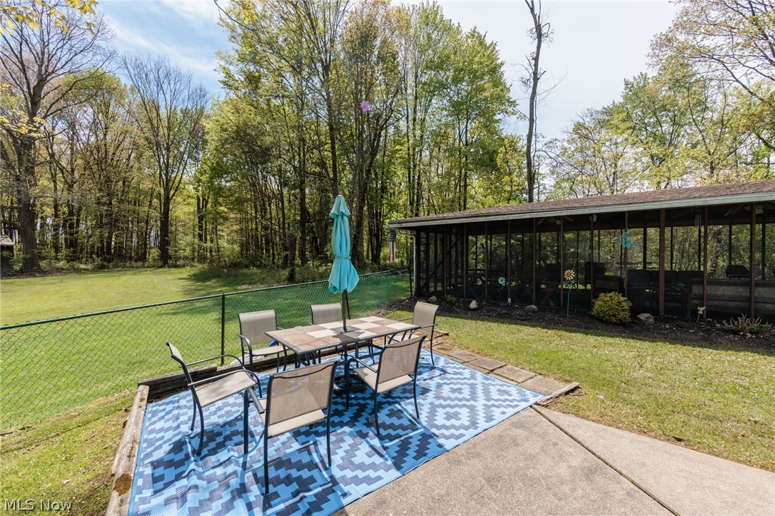 2170 Norton Road Stow, OH 44224 - Photo 11 of 48 Expansive backyard featuring a concrete patio, green lawn, and mature trees