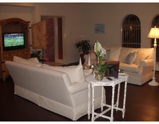 3535 Santa Fe Street, Unit 46 Corpus Christi, TX 78411 - Photo 1 of 4 a living room with furniture a flat screen tv and a large mirror