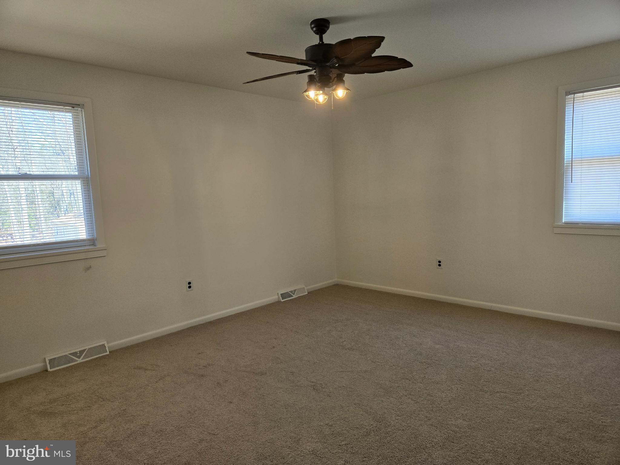 8 Sandy Drive Newfield, NJ 08344 - Photo 16 of 48 an empty room with a window and a fan