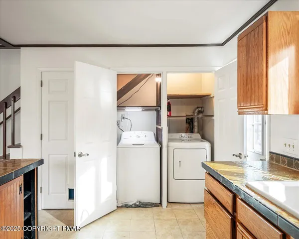 a kitchen with a sink a stove and a refrigerator