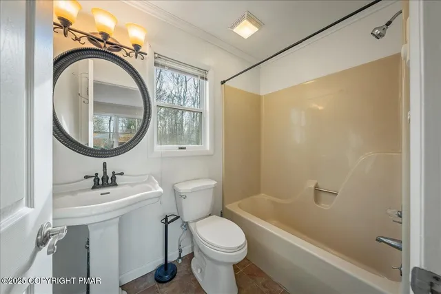 a bathroom with a sink toilet and a mirror