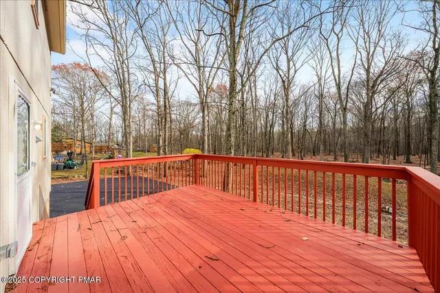 a view of balcony with wooden floor and fence