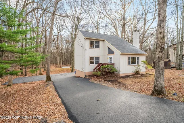 a view of a house with a yard covered in snow