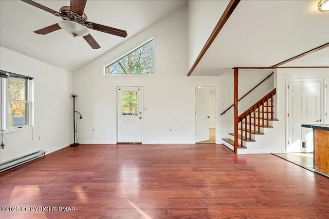 a view of an entryway with wooden floor