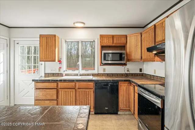 a kitchen with a sink stove and microwave