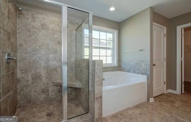 a bathroom with a bathtub and shower