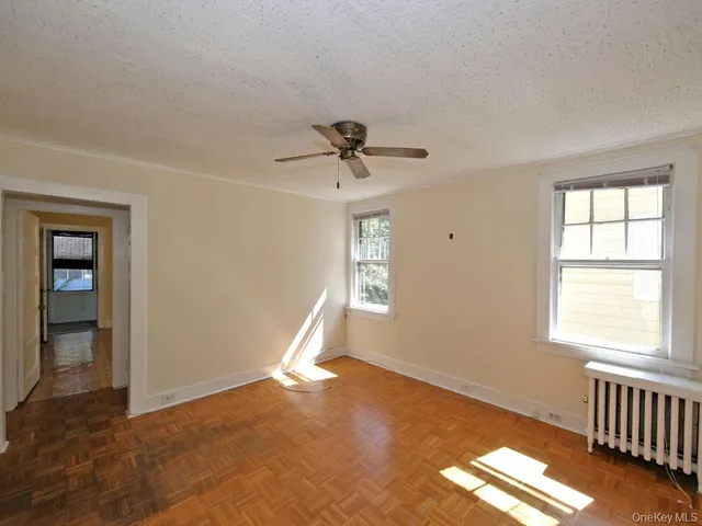 a view of a livingroom with a window and a ceiling fan
