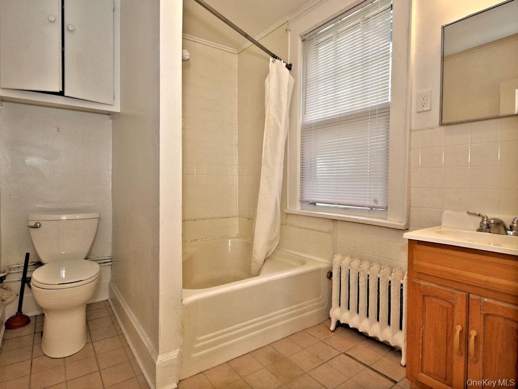 56 South Lawn Avenue, Unit 3 Elmsford, NY 10523 - Photo 7 of 7 a bathroom with a sink toilet and shower