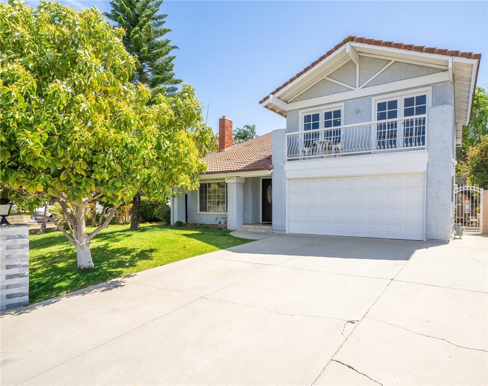23472 Stirrup Drive Diamond Bar, CA 91765 - Photo 1 of 7 a front view of a house with a yard and garage