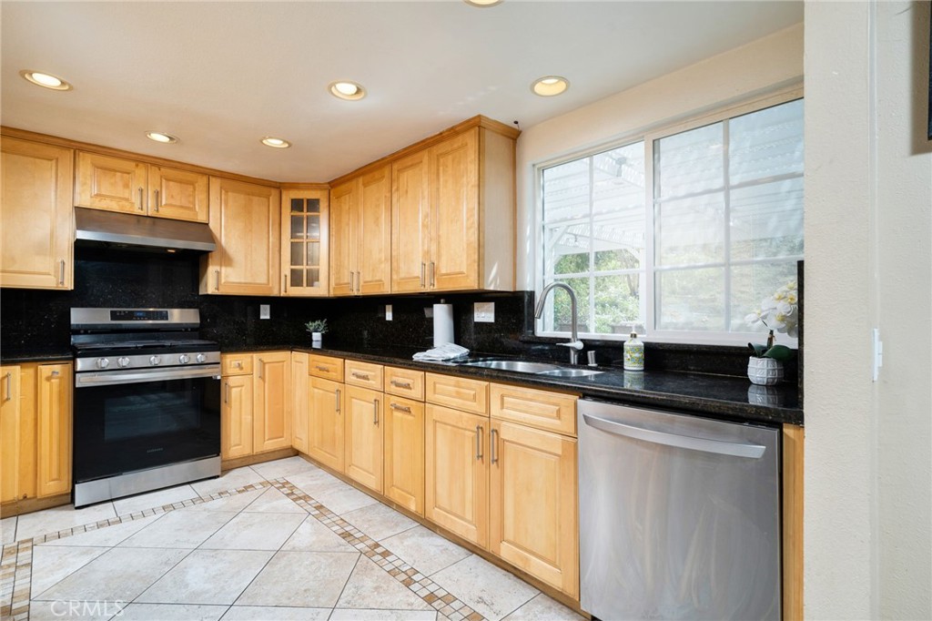 23472 Stirrup Drive Diamond Bar, CA 91765 - Photo 4 of 7 a kitchen with stainless steel appliances granite countertop a stove a sink and a microwave