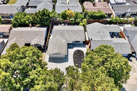 an aerial view of a fireplace with table and potted plants
