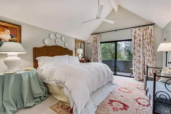 a bedroom with double bed and a large window