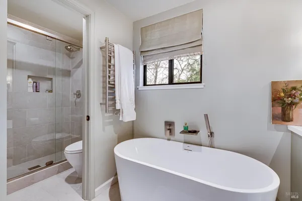 a white bath tub sitting next to a white toilet