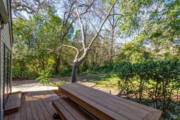 a view of a wooden deck with a yard