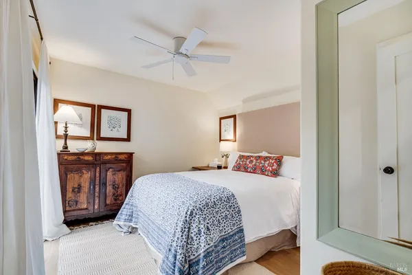 a bedroom with a bed dresser and a window