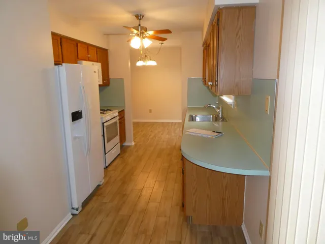 a bathroom with a sink a toilet a mirror and shower