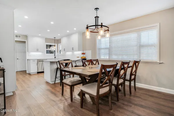 a view of a dining room with furniture wooden floor and chandelier