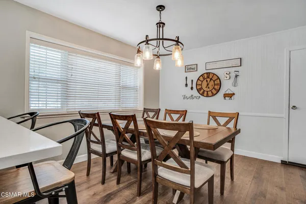 a dining room table with chair and window