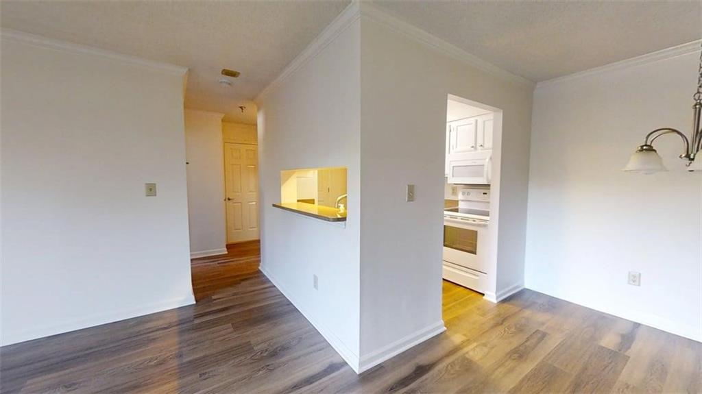 300 Johnson Ferry Road, Unit B409 Atlanta, GA 30328 - Photo 14 of 40 a view of a hallway with wooden floor