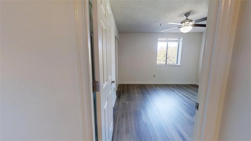 300 Johnson Ferry Road, Unit B409 Atlanta, GA 30328 - Photo 16 of 40 wooden floor in an empty room with a window