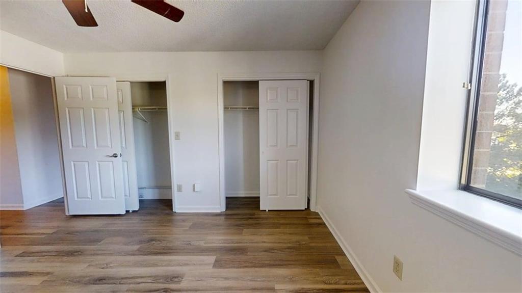 300 Johnson Ferry Road, Unit B409 Atlanta, GA 30328 - Photo 18 of 40 a view of an empty room with wooden floor and a window
