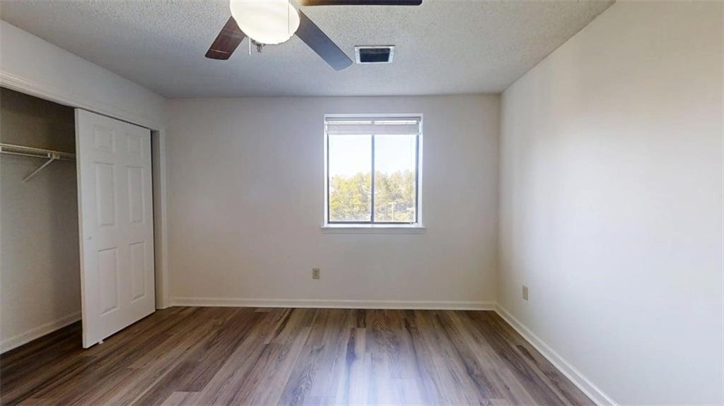 300 Johnson Ferry Road, Unit B409 Atlanta, GA 30328 - Photo 19 of 40 an empty room with wooden floor and windows