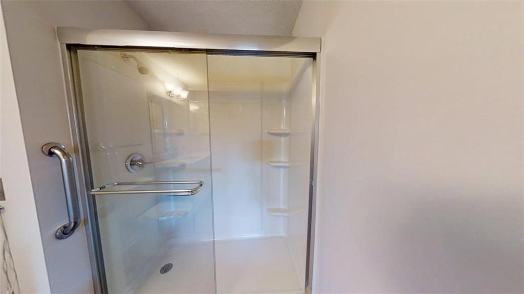 300 Johnson Ferry Road, Unit B409 Atlanta, GA 30328 - Photo 21 of 40 a bathroom with a glass shower door