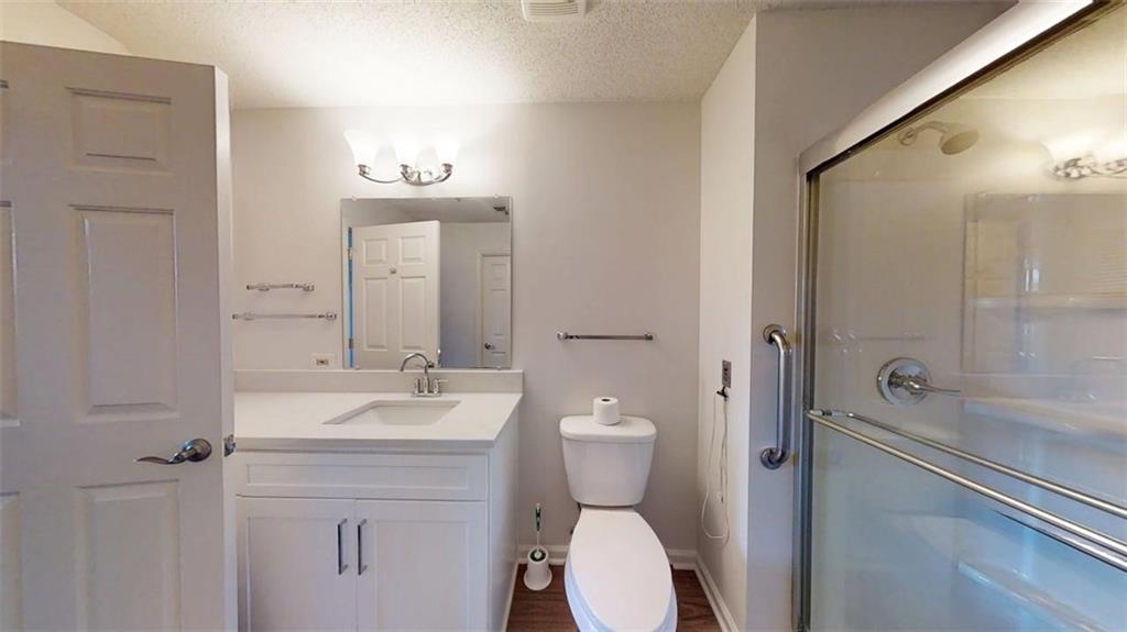 300 Johnson Ferry Road, Unit B409 Atlanta, GA 30328 - Photo 23 of 40 a bathroom with a sink a toilet and shower