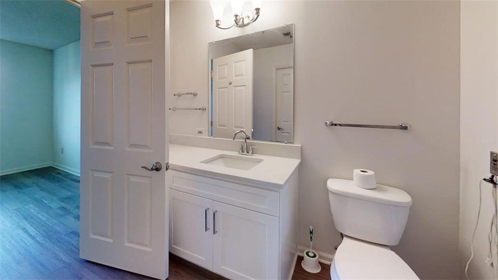 300 Johnson Ferry Road, Unit B409 Atlanta, GA 30328 - Photo 25 of 40 a bathroom with a toilet sink and mirror