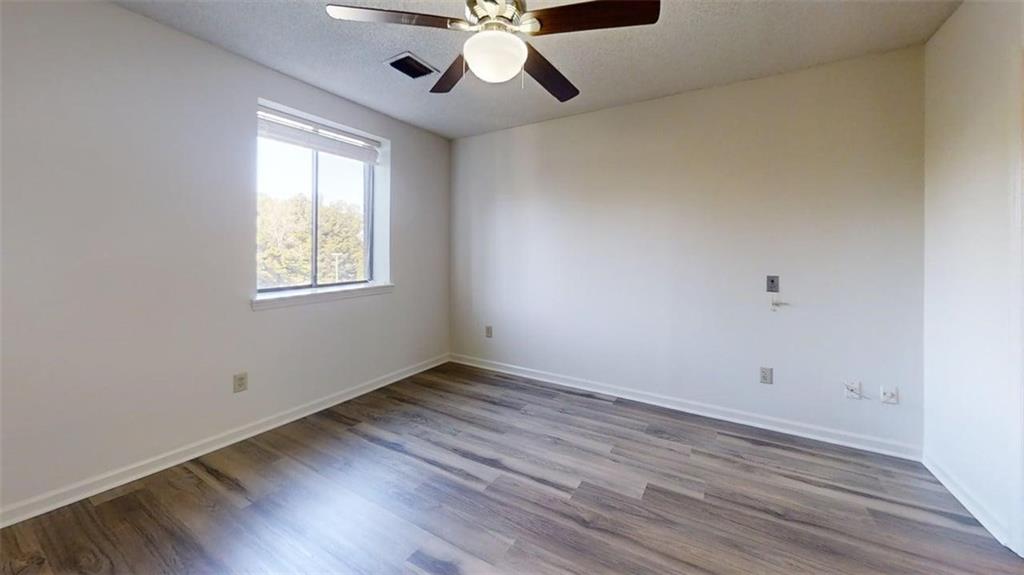 300 Johnson Ferry Road, Unit B409 Atlanta, GA 30328 - Photo 27 of 40 wooden floor in an empty room with a window