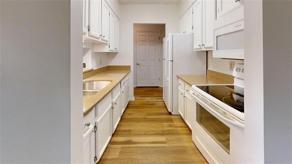 300 Johnson Ferry Road, Unit B409 Atlanta, GA 30328 - Photo 28 of 40 a view of a kitchen with wooden floor and staircase