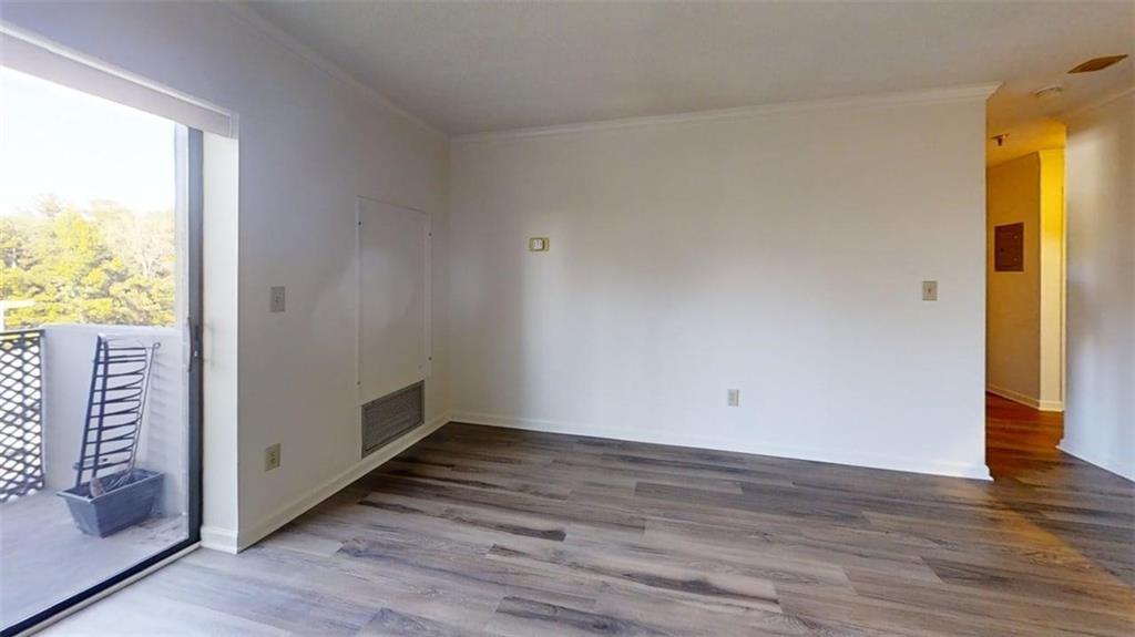 300 Johnson Ferry Road, Unit B409 Atlanta, GA 30328 - Photo 31 of 40 a view of an empty room with wooden floor and a window